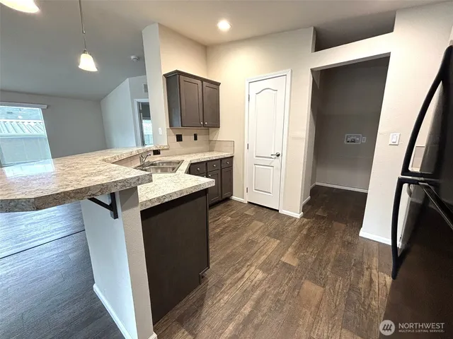 a kitchen with a sink stove and refrigerator