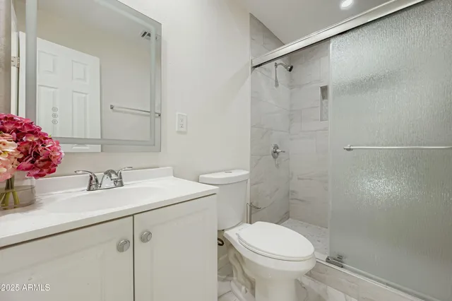 a view of a livingroom with a ceiling fan and window