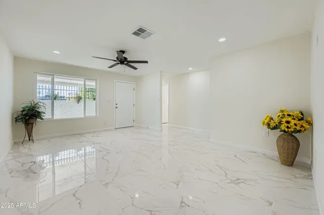 a kitchen with a sink a stove cabinets and chairs