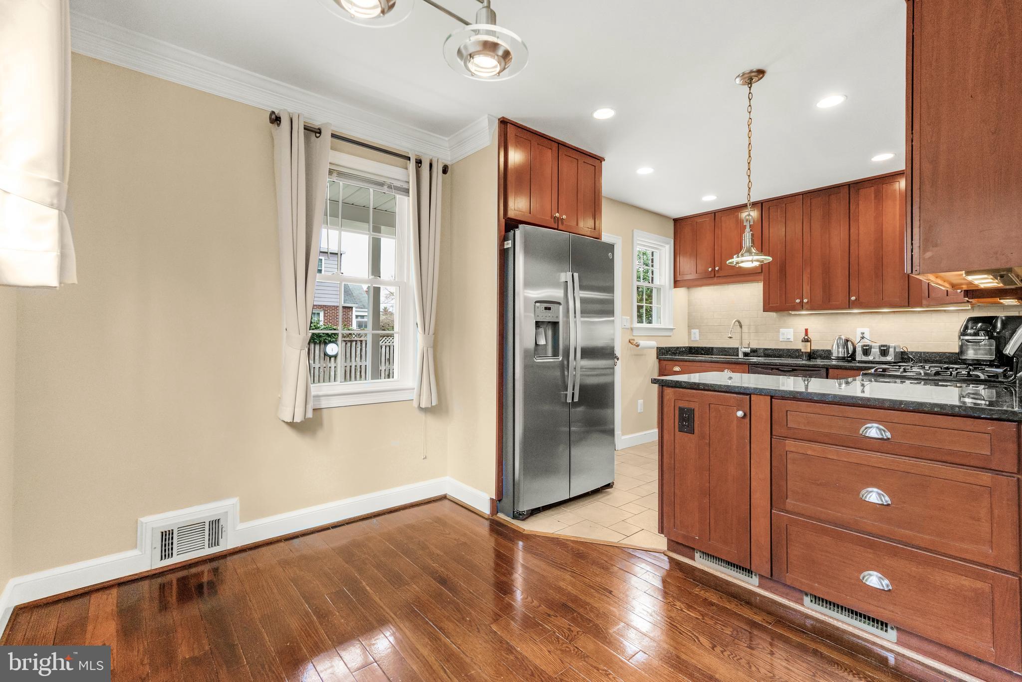 9505 Riley Road Silver Spring, MD 20910 - Photo 15 of 41 a kitchen with granite countertop wooden cabinets and a stainless steel appliances