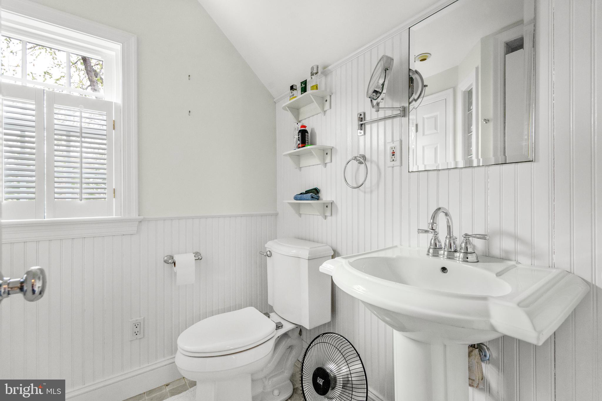 9505 Riley Road Silver Spring, MD 20910 - Photo 23 of 41 a bathroom with a sink a toilet and a mirror