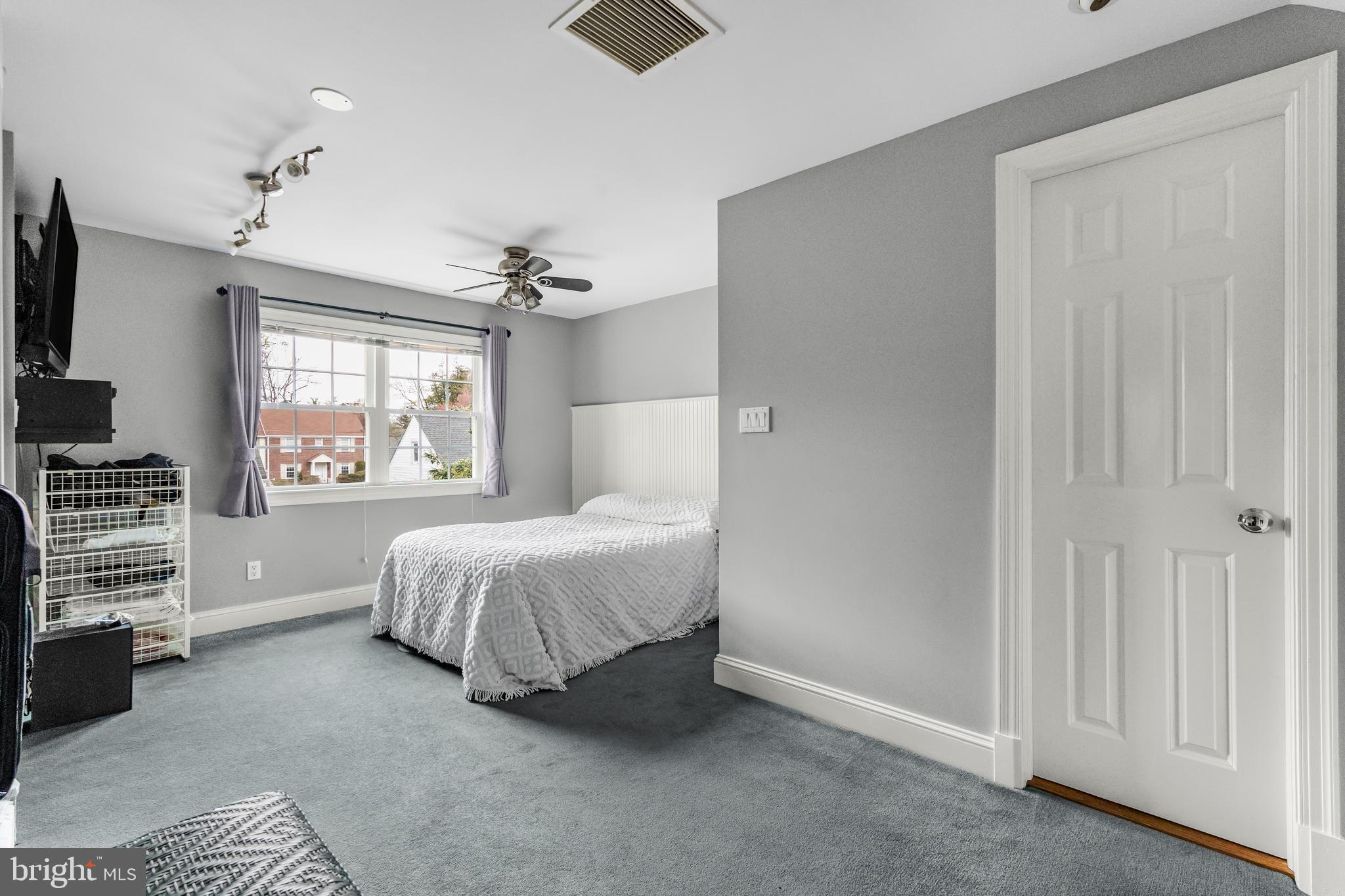 9505 Riley Road Silver Spring, MD 20910 - Photo 25 of 41 a spacious bedroom with a bed and a window