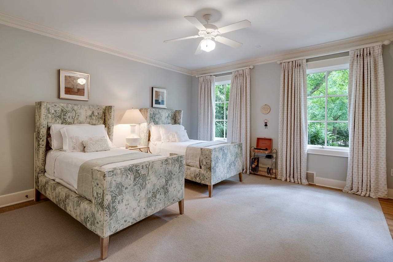4315 Tuckahoe Road Memphis, TN 38117 - Photo 18 of 25 a spacious bedroom with a bed and a chandelier