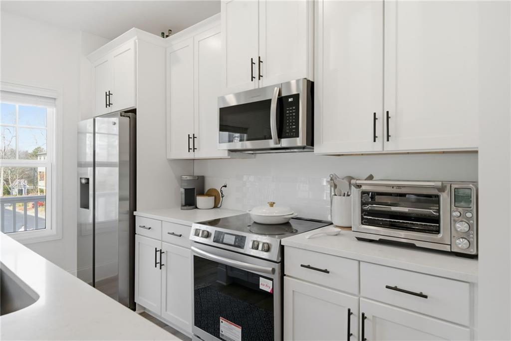 3158 Webb Road Milton, GA 30004 - Photo 13 of 36 a kitchen with stainless steel appliances white cabinets and a stove