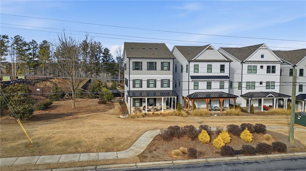 3158 Webb Road Milton, GA 30004 - Photo 26 of 36 a front view of a house with swimming pool and sitting area
