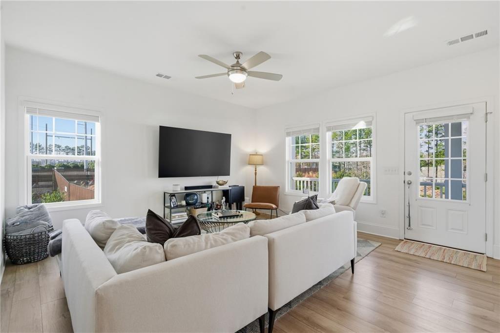 3158 Webb Road Milton, GA 30004 - Photo 5 of 36 a living room with furniture and a flat screen tv