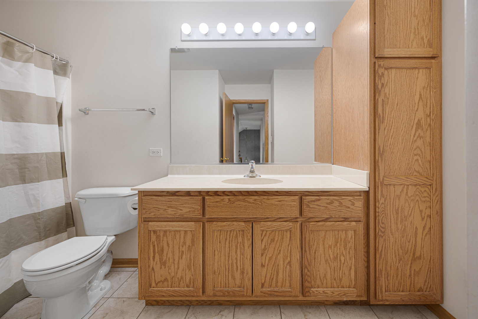 1014 Edinburgh Court Joliet, IL 60431 - Photo 16 of 25 a bathroom with a granite countertop toilet a sink and a mirror