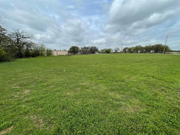 a view of a field with a big yard