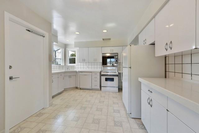 1501 Lloyd Way Mountain View, CA 94040 - Photo 4 of 8 a large white kitchen with a lot of counter space and appliances