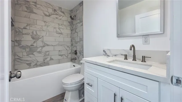 a bathroom with a sink a toilet and bathtub