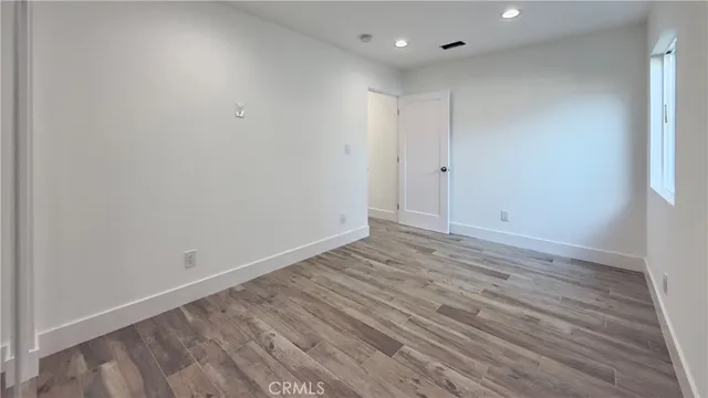 a view of room with wooden floor and window