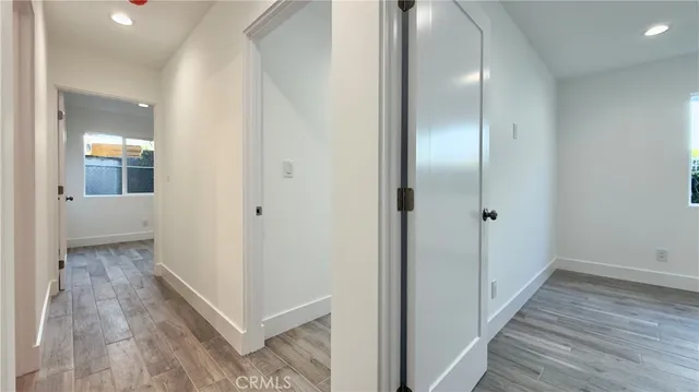 a view of a hallway with wooden floor