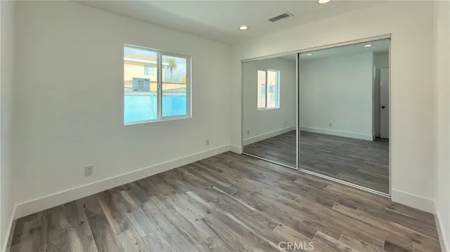 a view of wooden floor and windows in a room