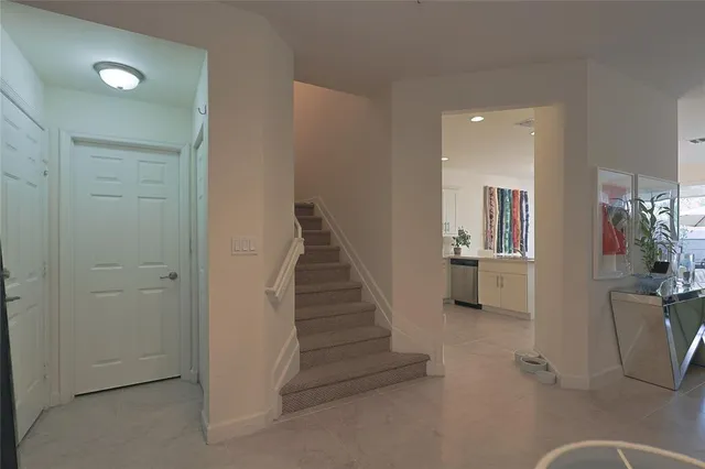 a view of a livingroom with wooden floor and stairs