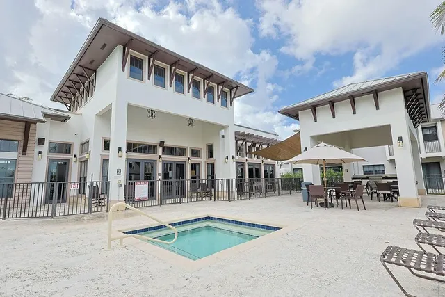 a view of a house with swimming pool and sitting area