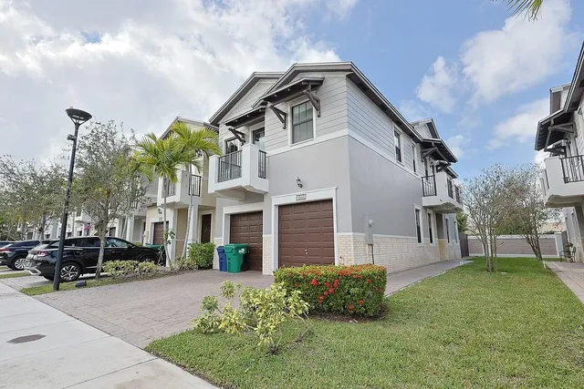 a front view of a house with a garden