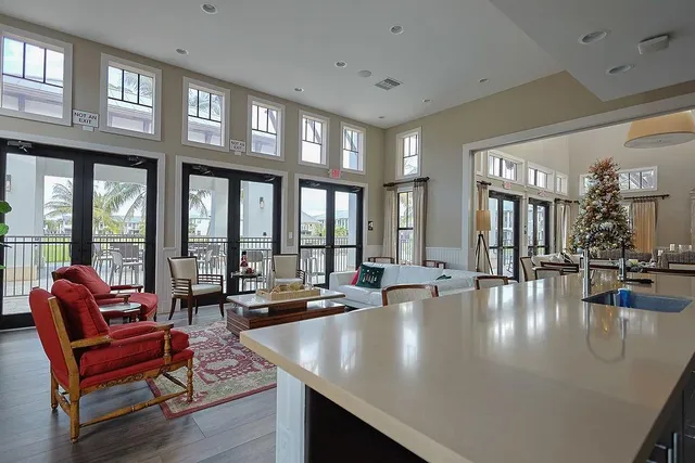 a living room with furniture chandelier and a large window