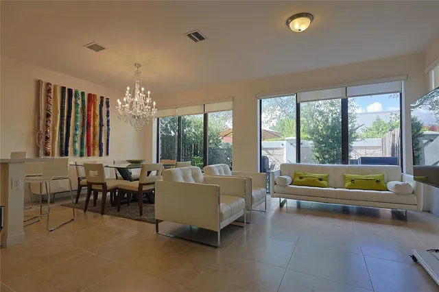 a living room with furniture and a chandelier