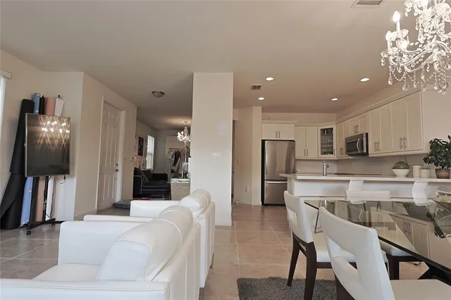 a large kitchen with white cabinets and stainless steel appliances
