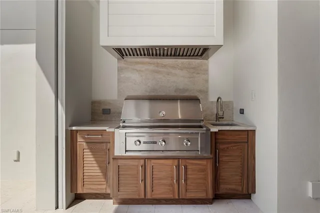 a stove top oven sitting inside of a kitchen