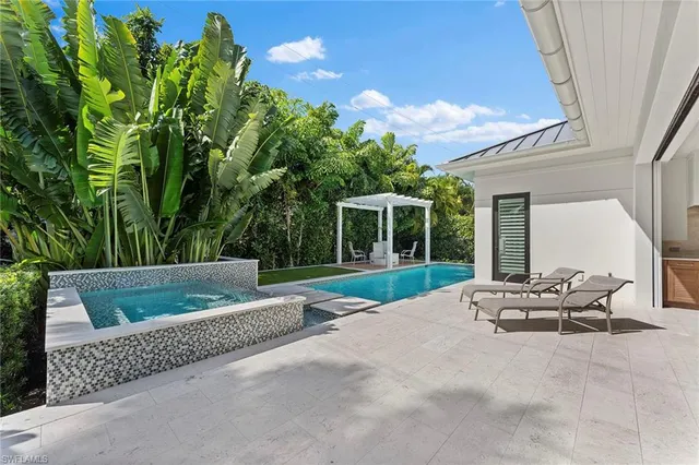a view of house with backyard and outdoor seating