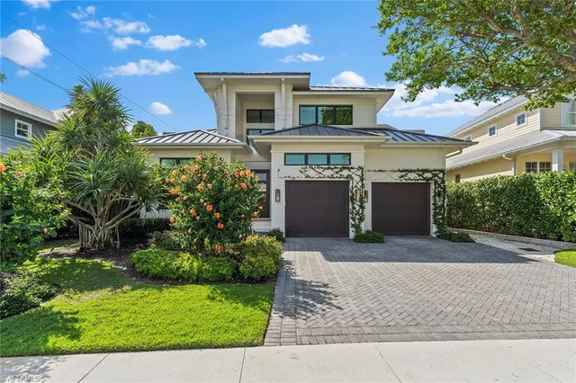 a front view of a house with a yard and a garage