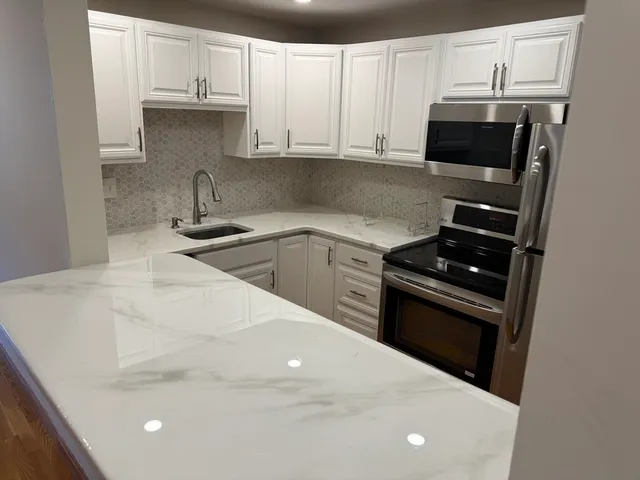 a kitchen with a sink and stainless steel appliances