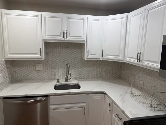 a kitchen with a sink and cabinets