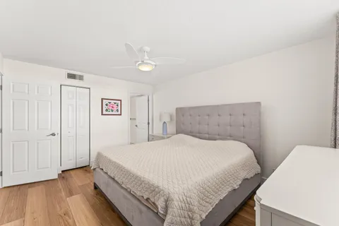 a bedroom with a bed and wooden floor