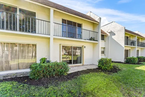 a view of a brick building next to a yard
