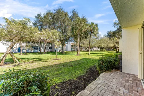 a view of a patio with table and chairs
