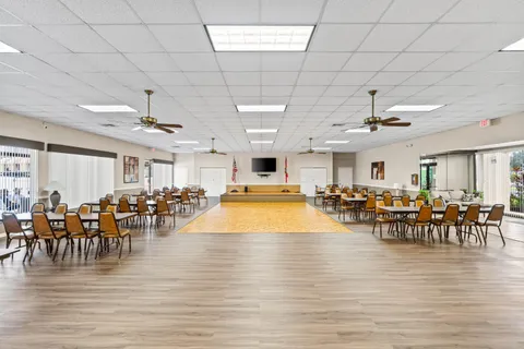 a kitchen with stainless steel appliances kitchen island granite countertop a refrigerator and a stove top oven