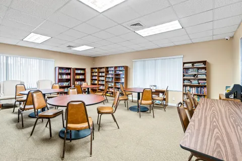 a room with pool table and windows