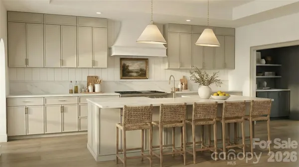 a kitchen with stainless steel appliances granite countertop a table chairs sink and cabinets
