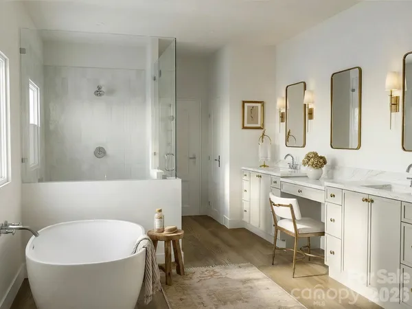 a bathroom with a white tub shower sink and mirror