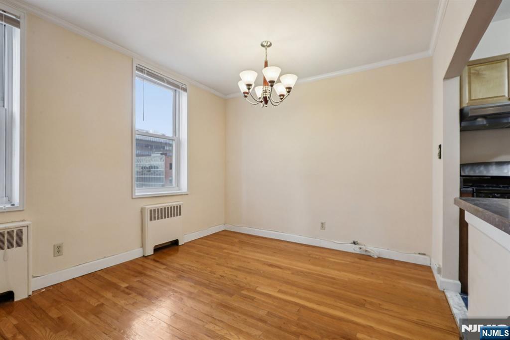 2160 Center, Unit 5N Fort Lee, NJ 07024 - Photo 11 of 30 a view of a room with wooden floor and chandelier
