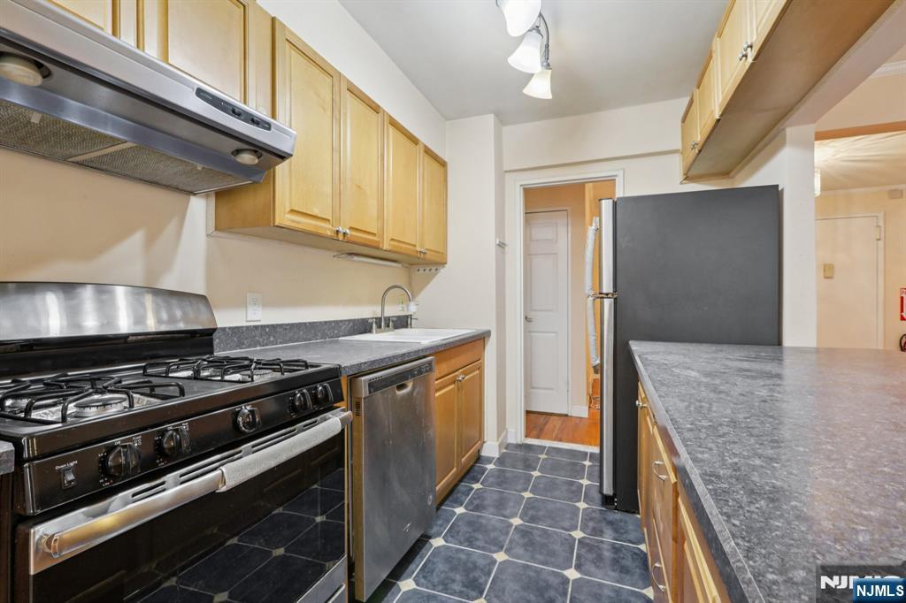 2160 Center, Unit 5N Fort Lee, NJ 07024 - Photo 12 of 30 a kitchen with stainless steel appliances granite countertop a stove and a refrigerator
