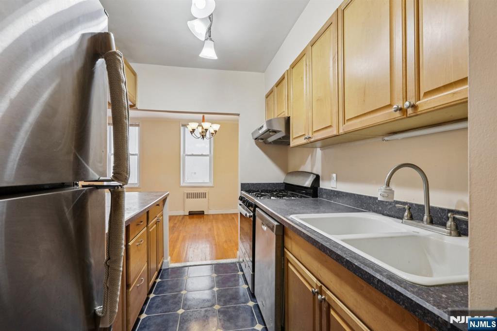 2160 Center, Unit 5N Fort Lee, NJ 07024 - Photo 13 of 30 a kitchen with stainless steel appliances granite countertop a sink a refrigerator and a sink