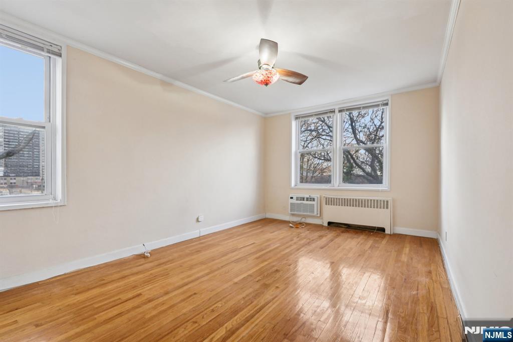 2160 Center, Unit 5N Fort Lee, NJ 07024 - Photo 22 of 30 a view of an empty room with wooden floor and a window