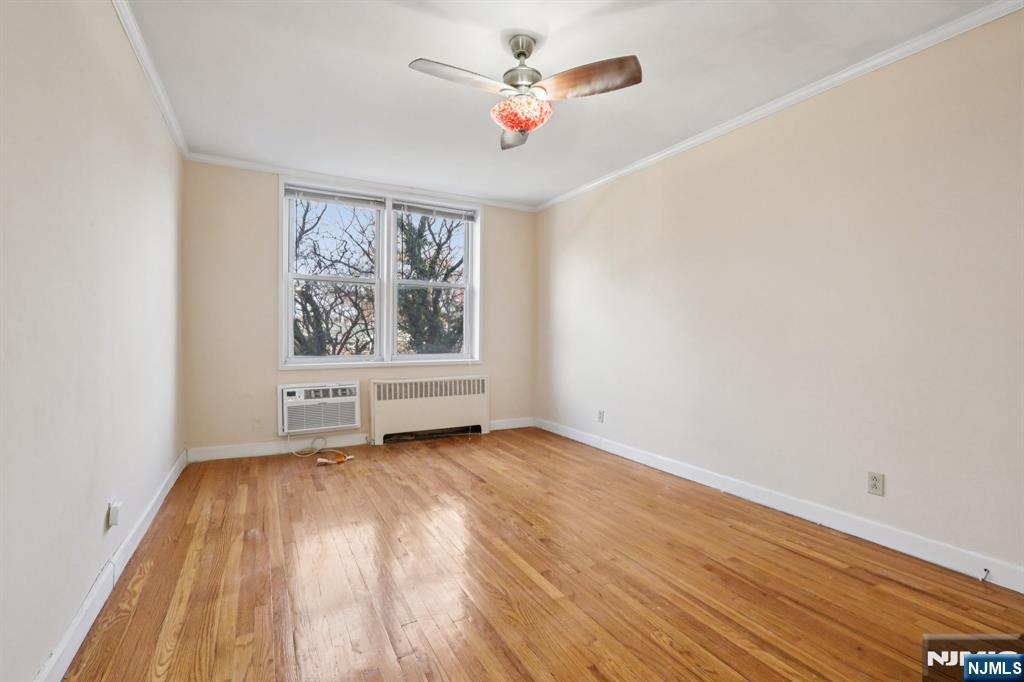 2160 Center, Unit 5N Fort Lee, NJ 07024 - Photo 23 of 30 an empty room with wooden floor chandelier fan and windows