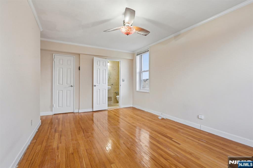 2160 Center, Unit 5N Fort Lee, NJ 07024 - Photo 24 of 30 a view of a room with wooden floor and a ceiling fan