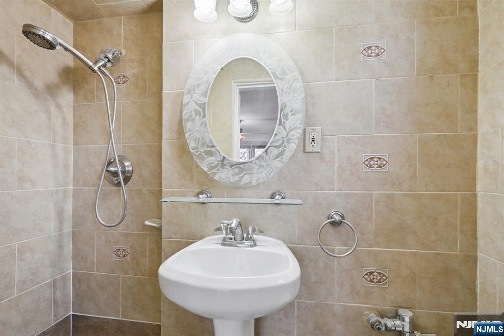 2160 Center, Unit 5N Fort Lee, NJ 07024 - Photo 25 of 30 a bathroom with a sink a toilet and shower
