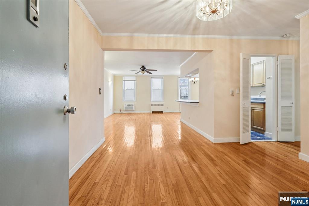 2160 Center, Unit 5N Fort Lee, NJ 07024 - Photo 5 of 30 a view of a hallway with wooden floor and a bathroom
