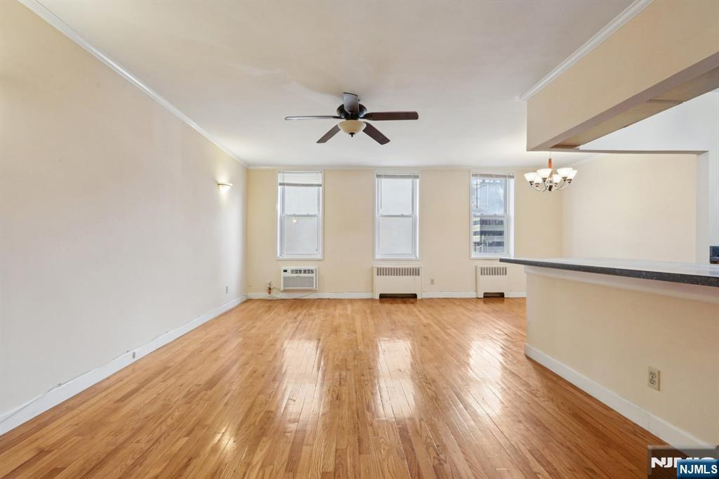 2160 Center, Unit 5N Fort Lee, NJ 07024 - Photo 6 of 30 an empty room with wooden floor ceiling fan and windows