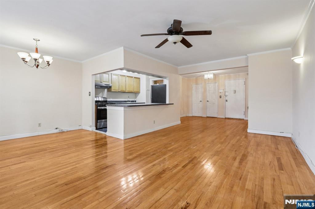 2160 Center, Unit 5N Fort Lee, NJ 07024 - Photo 8 of 30 a view of a livingroom with a chandelier fan and wooden floor