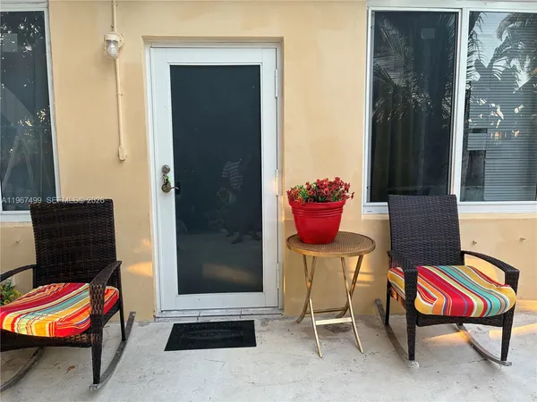 a backyard with a table and chairs