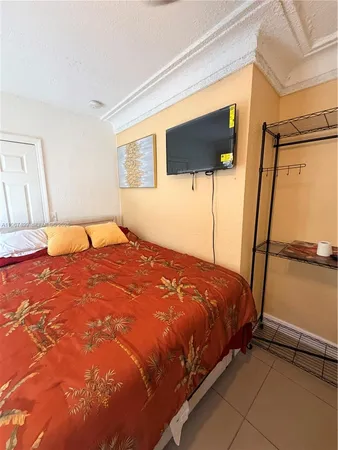 a bedroom with a bed and flat screen tv