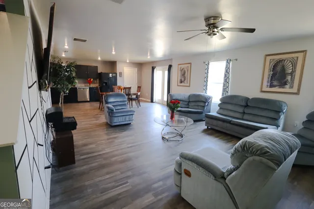 a living room with furniture or couch and a chandelier