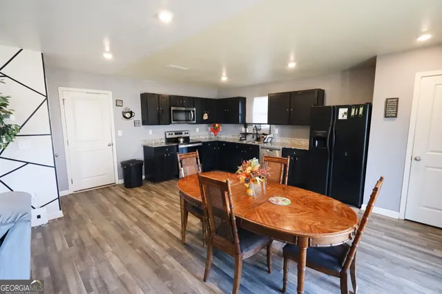 a view of a dining room with furniture and wooden floor