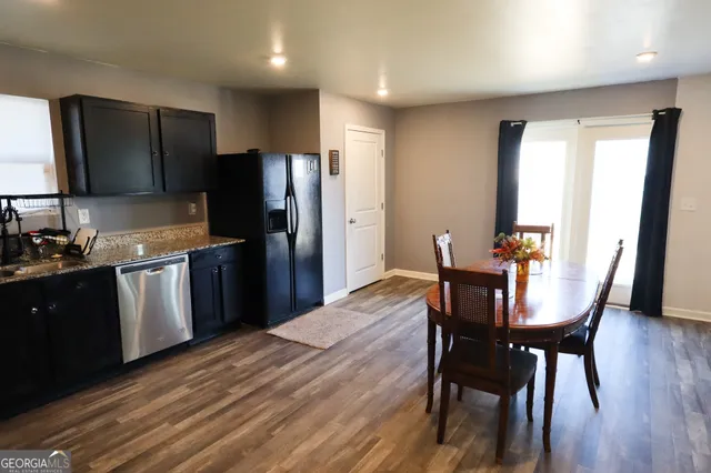 a kitchen with stainless steel appliances wooden floors and wooden cabinets